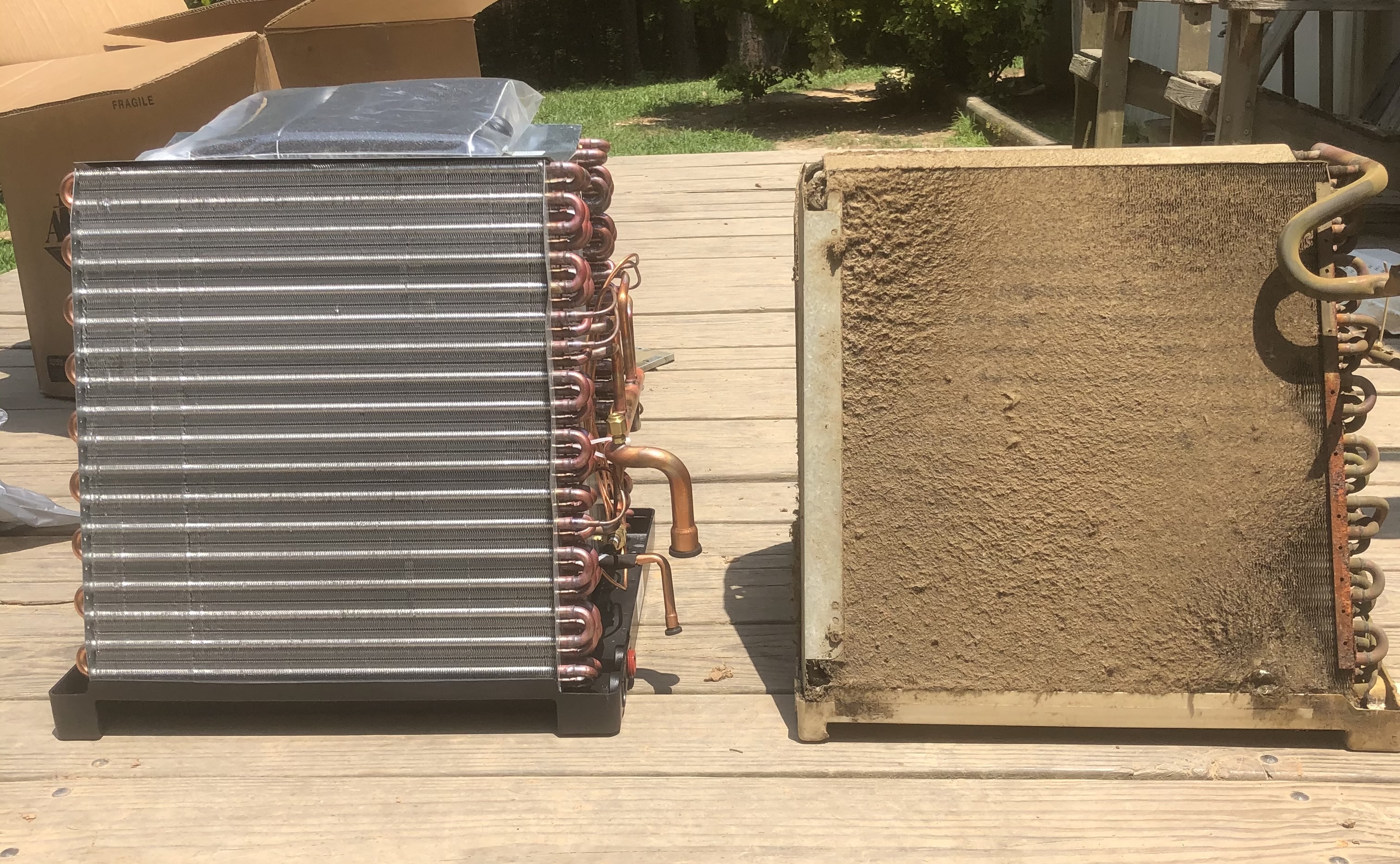 A clean HVAC evaporator coil next to a coil caked in dirt, side by side