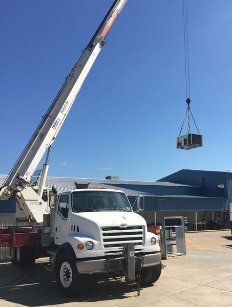 Thurmon's Heat & Air technician servicing an HVAC system in El Dorado, AR
